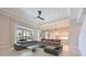 Spacious living room area featuring tile floors, a leather sectional and an adjacent modern kitchen at 17110 Verona Pl, Bradenton, FL 34202