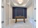 A modern home office with an accent wall, an ornate table, and glass paneled french doors at 17110 Verona Pl, Bradenton, FL 34202