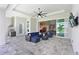 Covered lanai featuring comfortable wicker furniture and an outdoor kitchen for relaxing and entertaining at 17110 Verona Pl, Bradenton, FL 34202