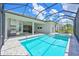 Back of house and pool with screened-in lanai, outdoor kitchen, and outdoor living spaces at 17110 Verona Pl, Bradenton, FL 34202