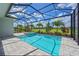 Backyard with a screened-in pool, lush landscaping, and views of manicured lawn at 17110 Verona Pl, Bradenton, FL 34202