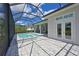 Back of house featuring a screened-in pool with spa and pavers on the pool deck and covered patio at 17110 Verona Pl, Bradenton, FL 34202