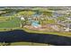 Aerial view showcases lakefront community amenities, including a pool, clubhouse, and green spaces, perfect for recreation at 17209 Barnwood Pl, Bradenton, FL 34211