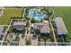 Aerial shot features community amenities, including a pool, clubhouse, parking, with mature landscaping at 17209 Barnwood Pl, Bradenton, FL 34211