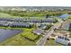 Aerial view of a community that includes townhomes, a pond, green space, and a community pool area at 17209 Barnwood Pl, Bradenton, FL 34211
