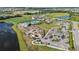 Extensive aerial view of a community, including amenities, a large parking lot, lakes, and beautiful landscaping at 17209 Barnwood Pl, Bradenton, FL 34211
