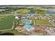 Expansive aerial view features community amenities including a pool, multiple lakes, a clubhouse, and green spaces at 17209 Barnwood Pl, Bradenton, FL 34211