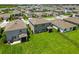 Rear aerial view of a home with a large backyard, neutral color palette, and screened patio at 17209 Barnwood Pl, Bradenton, FL 34211