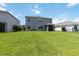 Spacious backyard featuring lush green grass and a screened-in patio perfect for relaxing outdoors at 17209 Barnwood Pl, Bradenton, FL 34211