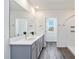 Bathroom with double vanity, quartz counters, gray cabinets, and a walk-in shower at 17209 Barnwood Pl, Bradenton, FL 34211