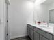 Bathroom boasts double sinks, granite countertops, and gray cabinets at 17209 Barnwood Pl, Bradenton, FL 34211