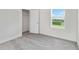 Bedroom with gray carpeting, white trim, a walk-in closet, and natural light from the window at 17209 Barnwood Pl, Bradenton, FL 34211