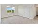 Bright bedroom features a large window, plush carpeting, and fresh neutral paint at 17209 Barnwood Pl, Bradenton, FL 34211