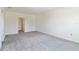 Spacious bedroom with plush gray carpeting and white walls is awaiting your personal touch at 17209 Barnwood Pl, Bradenton, FL 34211
