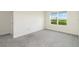 Bright bedroom features a large window, plush carpeting, and fresh neutral paint at 17209 Barnwood Pl, Bradenton, FL 34211