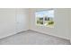Bright bedroom features a large window, plush carpeting, and fresh neutral paint at 17209 Barnwood Pl, Bradenton, FL 34211