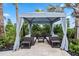 Private cabana with comfortable seating and tropical landscaping for relaxation at 17209 Barnwood Pl, Bradenton, FL 34211