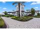 Beautiful clubhouse showcasing a three-story tower and a brick-paved walkway surrounded by greenery at 17209 Barnwood Pl, Bradenton, FL 34211