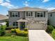 Charming two-story home with stone accents, landscaped yard, and a two-car garage at 17209 Barnwood Pl, Bradenton, FL 34211