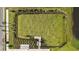Aerial view of a large, meticulously maintained green space, bordered by landscaping and a paved walkway at 17209 Barnwood Pl, Bradenton, FL 34211