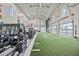 Bright gym equipped with a variety of weight training equipment, turf, and expansive glass doors at 17209 Barnwood Pl, Bradenton, FL 34211