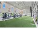 Spacious gym featuring turf, workout equipment, natural light, and large glass doors that provide indoor-outdoor space at 17209 Barnwood Pl, Bradenton, FL 34211
