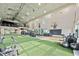 Large gym with high ceilings, turf, basketball hoop, weight machines, and a balcony space for additional workouts at 17209 Barnwood Pl, Bradenton, FL 34211