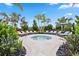 Inviting outdoor hot tub surrounded by lounge chairs and tropical landscaping at 17209 Barnwood Pl, Bradenton, FL 34211