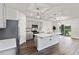 Modern kitchen with stainless steel appliances, grey cabinets, stylish island, and a sliding glass door at 17209 Barnwood Pl, Bradenton, FL 34211
