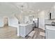 Open-concept kitchen featuring a large island, stainless steel appliances, and light grey cabinetry at 17209 Barnwood Pl, Bradenton, FL 34211