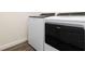 Laundry room featuring modern, white Whirlpool washer and dryer at 17209 Barnwood Pl, Bradenton, FL 34211