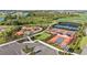 Aerial view of a community park with a playground, multi-use sports courts, and lush landscaping at 17209 Barnwood Pl, Bradenton, FL 34211