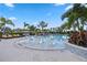 Resort-style pool featuring in-water lounge chairs and lush tropical landscaping at 17209 Barnwood Pl, Bradenton, FL 34211