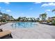 Sparkling pool with sun loungers and umbrellas for residents' relaxation at 17209 Barnwood Pl, Bradenton, FL 34211