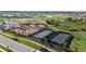 Aerial view of a community park featuring pickleball, basketball, and tennis courts with a playground nearby at 17209 Barnwood Pl, Bradenton, FL 34211
