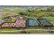 Aerial view of community sports courts including tennis, basketball, and pickleball near a playground and green space at 17209 Barnwood Pl, Bradenton, FL 34211