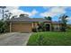 Charming single-story home with a well-manicured lawn and an attached two-car garage at 17215 Berwin Ave, Port Charlotte, FL 33948