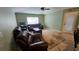 Relaxing living room with comfortable leather couches, a ceiling fan, and natural light at 17215 Berwin Ave, Port Charlotte, FL 33948