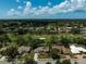 Aerial view of a golf community with homes featuring well maintained landscaping and mature trees at 2016 White Feather Ln, Nokomis, FL 34275