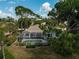 Home exterior showing a backyard with a screened-in pool and patio surrounded by manicured landscaping at 2016 White Feather Ln, Nokomis, FL 34275