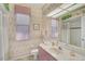 Quaint bathroom with floral wallpaper, and a shower with curtains at 2016 White Feather Ln, Nokomis, FL 34275