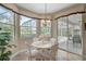 Bright breakfast nook features large windows with views of the outdoor pool and landscaping at 2016 White Feather Ln, Nokomis, FL 34275