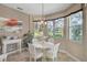 Cozy breakfast nook with a chandelier and a view of the lush green outdoors at 2016 White Feather Ln, Nokomis, FL 34275