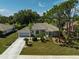 Well-maintained home with mature landscaping, tile roof, and a two-car garage on a sunny day at 2016 White Feather Ln, Nokomis, FL 34275