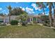Beautiful home featuring a manicured lawn, mature landscaping, and a welcoming entrance at 2016 White Feather Ln, Nokomis, FL 34275