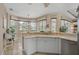 Open kitchen area featuring light countertops, stainless steel appliances, and ample natural light at 2016 White Feather Ln, Nokomis, FL 34275