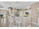Stylish kitchen with counter seating, stainless appliances, and bright recessed lighting at 2016 White Feather Ln, Nokomis, FL 34275