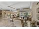 Open concept living room with tile floors, neutral decor, and access to the outdoor screened lanai at 2016 White Feather Ln, Nokomis, FL 34275