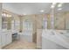 Elegant main bathroom with a soaking tub, a vanity, and a tiled walk-in shower at 2016 White Feather Ln, Nokomis, FL 34275