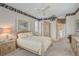 Spacious main bedroom with a ceiling fan, and a glimpse into the connected bathroom at 2016 White Feather Ln, Nokomis, FL 34275